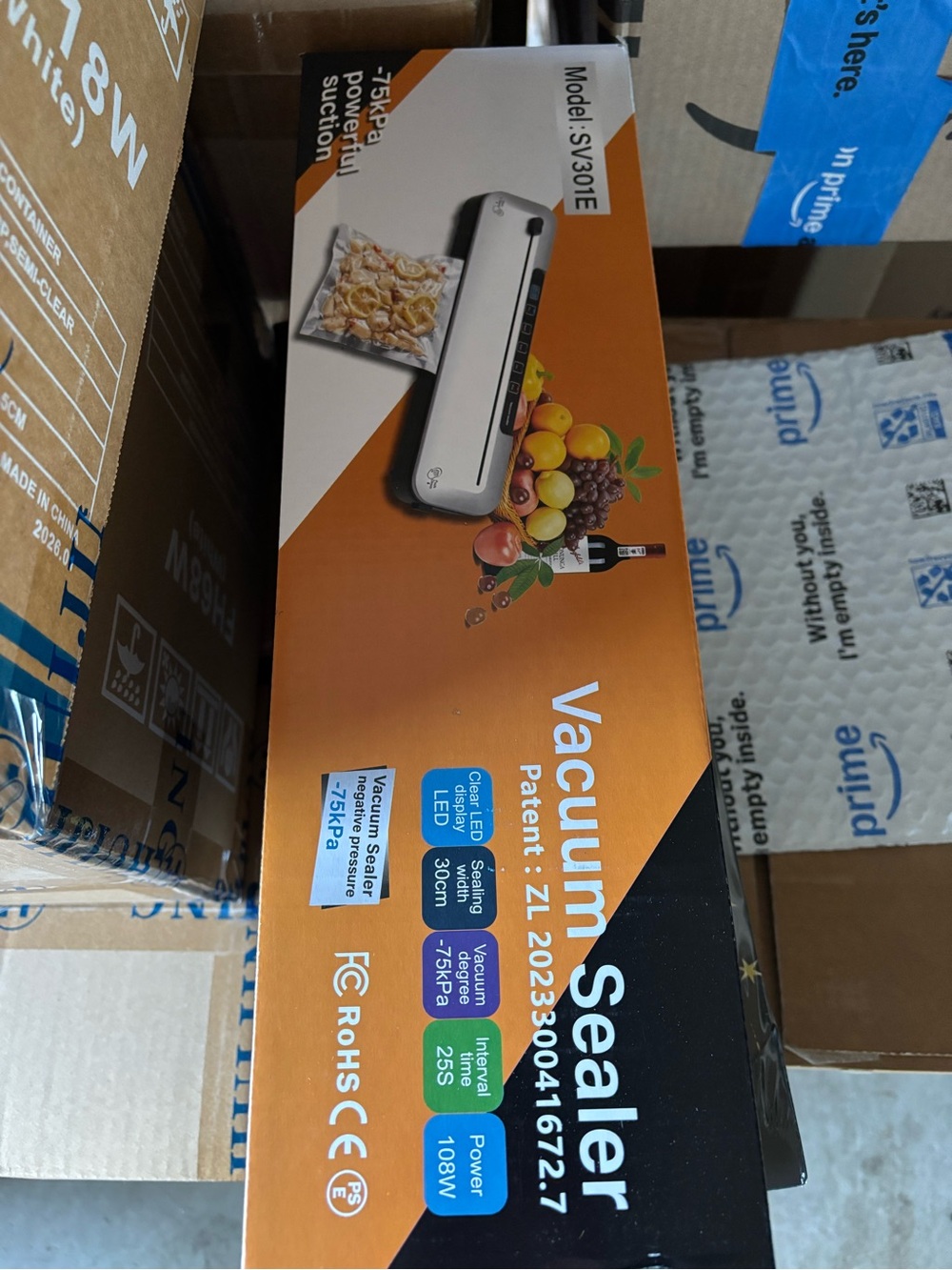 Vacuum Sealer Machine in Orange and Black Packaging